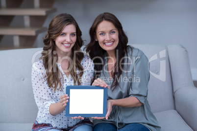 Two beautiful woman holding digital tablet