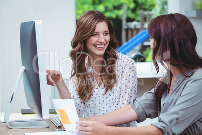 Two beautiful woman using computer