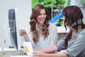 Two beautiful woman using computer