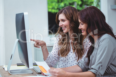 Two beautiful woman using computer