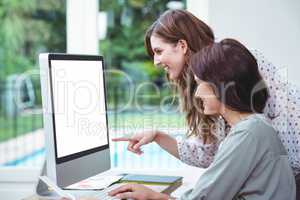 Two beautiful woman using computer