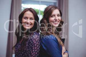 Portrait of beautiful women standing back to back