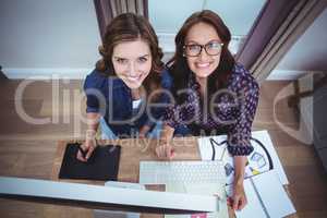 Two beautiful women using computer