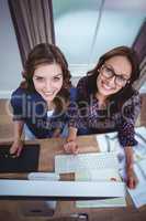 Two beautiful women using computer