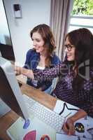 Two beautiful women using computer
