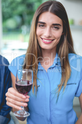 Beautiful woman holding a glass of red wine