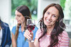 Beautiful woman holding a glass of red wine