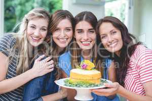 Portrait of beautiful women holding a birthday cake