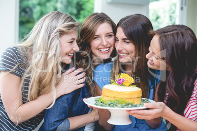 Beautiful women holding a birthday cake