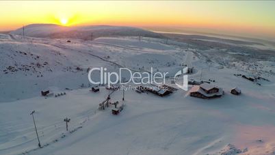 Flying over ski resort in the north at sunset