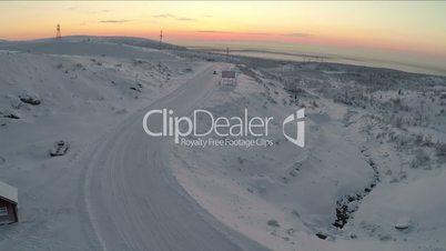Aerial view of car driving snowy road and drifting