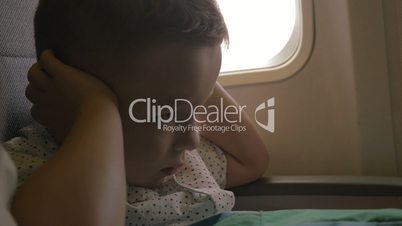 Kid shutting ears at the airplane