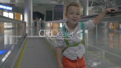 Cute little boy on travelator in airport