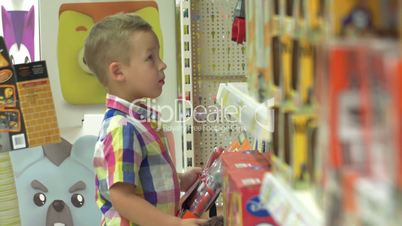 Boy Choosing Toys in the Shop