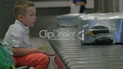 Child waiting at the baggage claim area