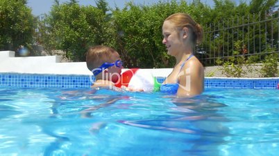 Woman, Boy and Ball in Swimming Pool