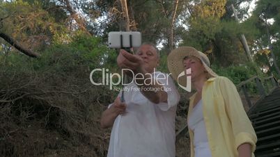Mature Couple Taking Selfie with Monopod Stick