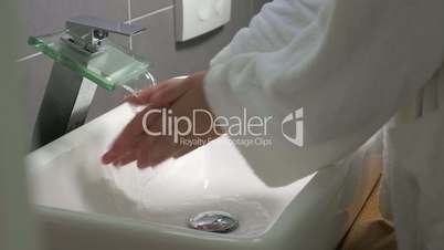 Woman washing hands with liquid soap