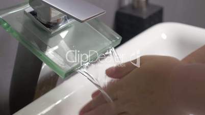 Washing female hands with soft soap