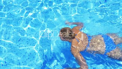 Woman Swimming in Open-Air Swimming Pool