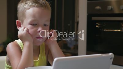 Child having meal with cartoons on pad