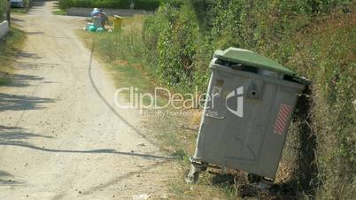 Woman Taking Out the Litter to Street Container