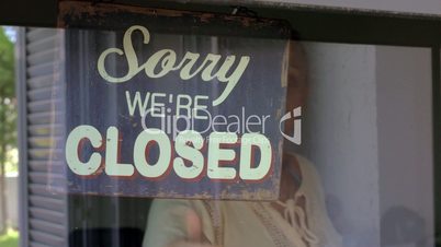 Woman closing the shop or cafe