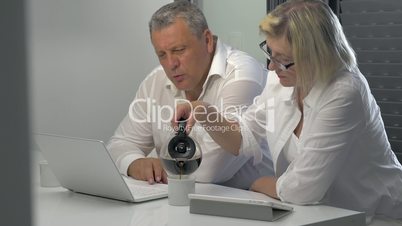 Mature Businesspeople with Coffee and Laptop