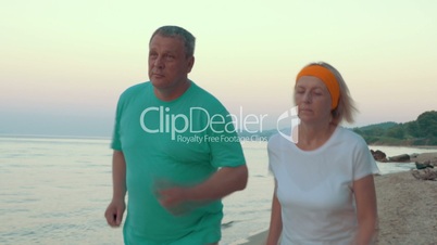 Mature Couple Jogging on the Beach