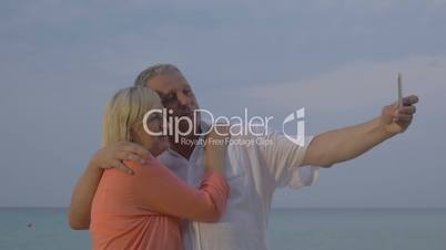 Senior couple making vacation selfie on mobile