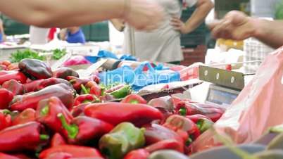 Buying red peppers on street market
