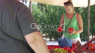Young Woman Buying Tomatoes at Street Vendor Stall