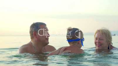 Grandparents Teaching Boy Swimming Underwater