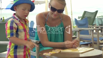 Child learning numerals playing with mom outdoor