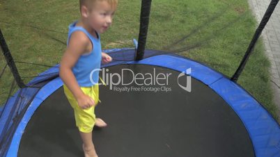 Child jumping inside protected outdoor tramp