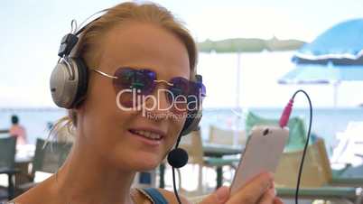 Woman in headset video chatting on mobile