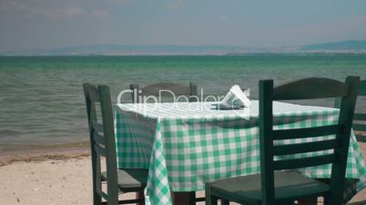 View on table and four chairs on coastline