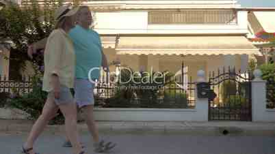 Couple of tourists walking by private houses