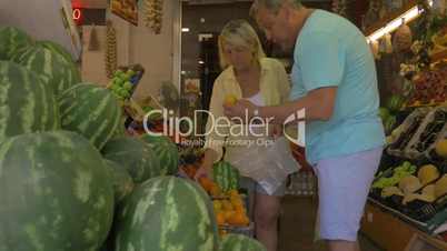 Mature Couple Choosing Fruit in Grocery Store