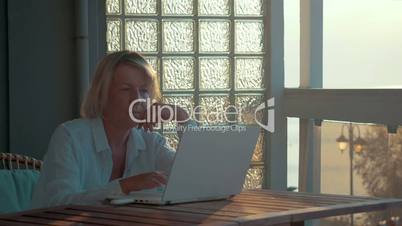 Woman using laptop and mobile internet device