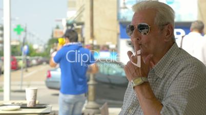 Close-up of senior man smoking cigarette