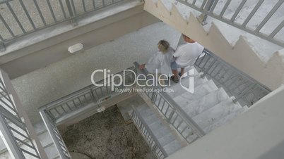 Couple Walking Down the Spiral Stairs