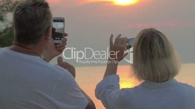 People Shooting Sea Sunset at Smartphones