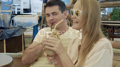 Young couple having coffee cocktails in cafe