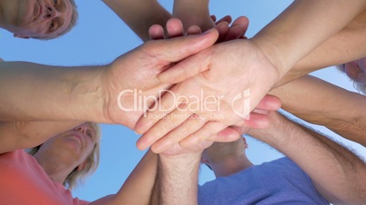 People Putting Hands Together and Lifting Them Up