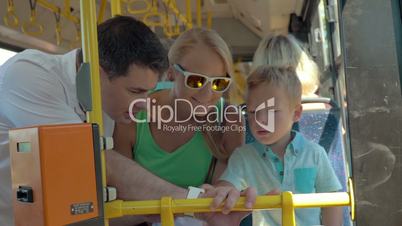 Child using fathers smartwatch during bus ride