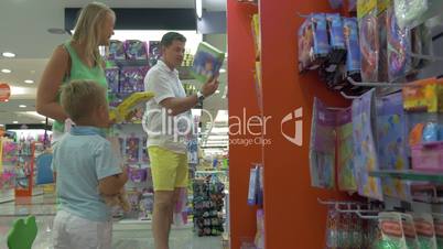 Mother, father and son in toy shop