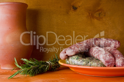 Raw pork sausages and a bunch of rosemary