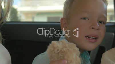 Boy with Plush Toy on the Car Back Seat