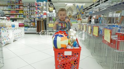 Child going shopping in the supermarket